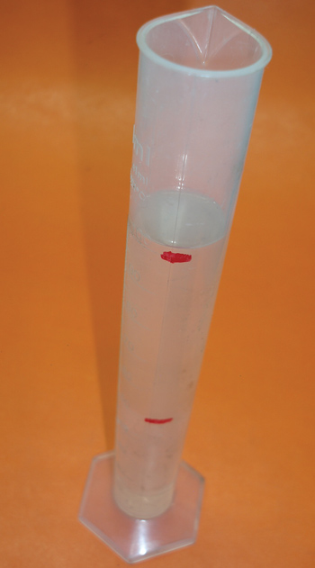 this inexpensive, 100-milliliter (ml) graduated cylinder is available from any major on-line speed equipment company. the first step is to add water to the 50 ml mark. note that lighting in the photograph causes the fluid ­levels to appear slightly higher.