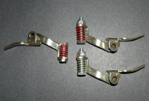 the holley carburetor pump arm on the left has the original duration spring design from the 1960s & 1970s. the new design pump arm on the upper right is more adjustable, but the duration spring is not as strong as the original design. the pump arm on the lower right has a duration spring that is used on the demon carburetors. the stronger duration spring makes the accelerator pump more active, which improves throttle response.