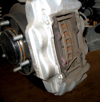 Figure 3: To fit the larger brake caliper, it is necessary to trim the backing plate/dust shield.