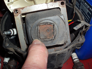 photo 2: arcing between the ignition coil and distributor rotor burned away the insulation on the coil and the center portion of the distributor cap. 