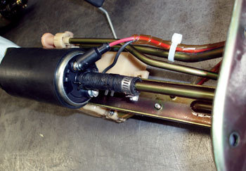 Tie down loose fuel pump wiring to prevent  interference with the fuel level sensor float assembly. In some cases, lower-than-indicated fuel levels can cause driveability complaints.  