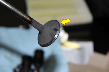 Photo 6: A burnt exhaust valve was our guilty party. 