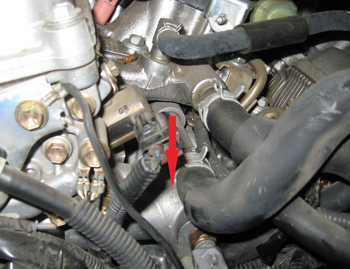 photo 9: the red arrow indicates the thermostat housing.