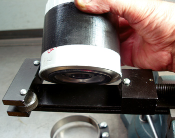 Photo 3: Oil filter cutters are handy for detecting metallic debris trapped in the oil filtering media. The duct tape helps the filter wrench grip the filter canister.