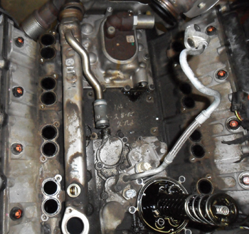 the egr cooler lies in the upper valley of the engine beneath the intake manifold. here the intake has been removed to show its location between the oil cooler and cylinder head on the ­passenger side of the engine.