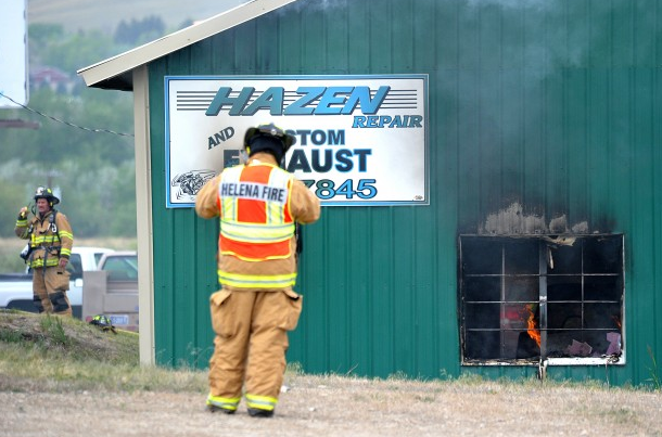 Helena firefighters work on a plan of attack Tuesday, after Hazen Repair and Custom Exhaust's shop caught fire. Dylan Brown Independent Record