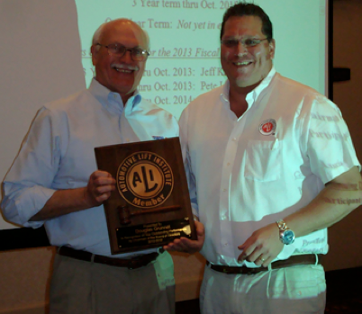 ALI President R. W. (Bob) O'Gorman (right) presents a service plaque to outgoing ALI Chairman Douglas Grunnet at the organization's recent annual meeting.