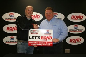 New Hampshire Motor Speedway vice president and general manager Jerry Gappens (right) and Bond Auto Parts vice president of marketing Mark Mast shake on a new deal that makes Bond the “Official Auto Part Retailer” of NHMS.