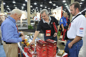 Attendees of the Aftermarket Auto Parts Alliance 2009 convention in Nashville speak to a vendor on the show floor. Photo by Pat Garin, www.patgarinphotographer.com