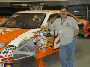 Ricky McGary of Shreve Automotive in Austin, TX, stands next to a no. 20 Home Depot that was used to conduct the Raybestos Chassis Master Technician clinic.