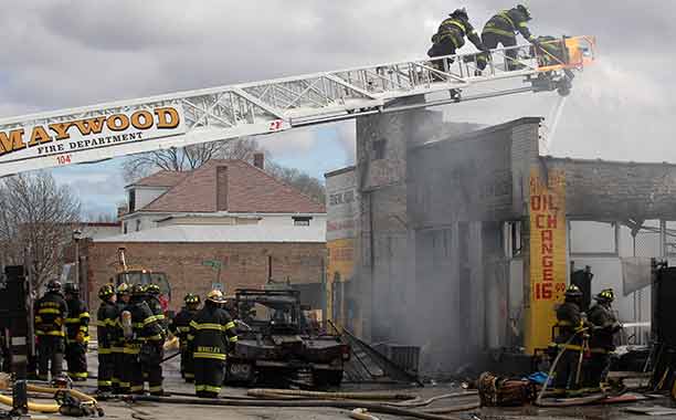 Maywood firefighters, along with firefighters from neighboring western suburbs, battle a 3-11 alarm blaze in the 1400 block of St. Charles Road. (Warren Skalski/Photo for the Tribune)