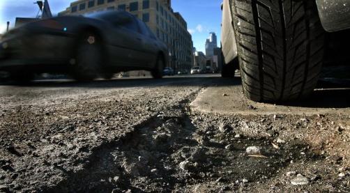 Remember winter? Maybe a trip through a local road chasm will jog your memory – and jar loose a few of your car's parts. (Jim Gehrz, Star Tribune)