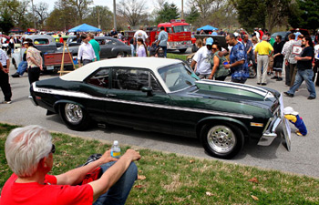 APRIL 4, 2010 - Wonel Brown (center) hugs JuJuan Holman-Woods and greets her husband, Corey Woods, while showing off his son's 1969 Chevy Nova at the 49th Annual Concours d'Elegance and Easter Car Show at Forest Park. (Elie Gardner/P-D)