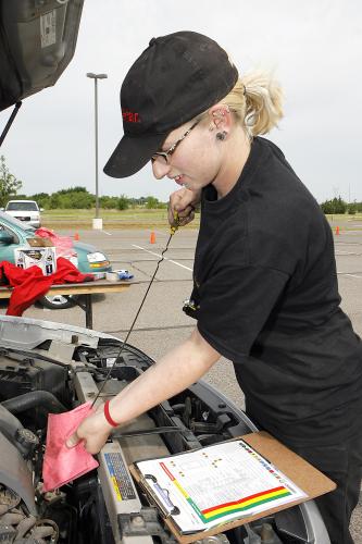 Isla Prater checks the oil in a car at the Kwik Kar auto safety inspection at the Edmond Senior Center in 2008. (PHOTO BY DAVID MCDANIEL, OKLAHOMAN ARCHIVE)