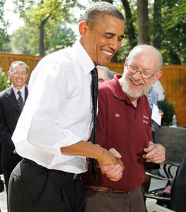 President Barack Obama shakes hands with Jim Houser of Portland in the backyard of a private residence in Falls Church, Va., on Wednesday after discussing the Patient's Bill of Rights and health care reform. Houser owns an auto repair shop and employs 15 people. (The Associated Press)