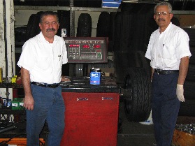 Jim and Abe Torro, co-owners of Orange Auto Center in Orange, CA, with their ancient Coats balancer.