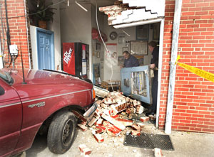 A pickup crashed into the wall at Minnick's Auto Repair and Towing on Cecil Street in Winchester on Wednesday morning. No one was injured in the crash. (Dennis Grundman/Daily)
