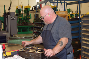 An employee stamps the SK logo onto sockets manufactured in Sycamore, IL. All SK tools are made in the United States.
