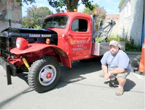 Kurt Knapp of Waverly, N.Y., poses for a photo on Sunday next to the 1950 tow truck that he is restoring. Review Photo/James Loewenstein.